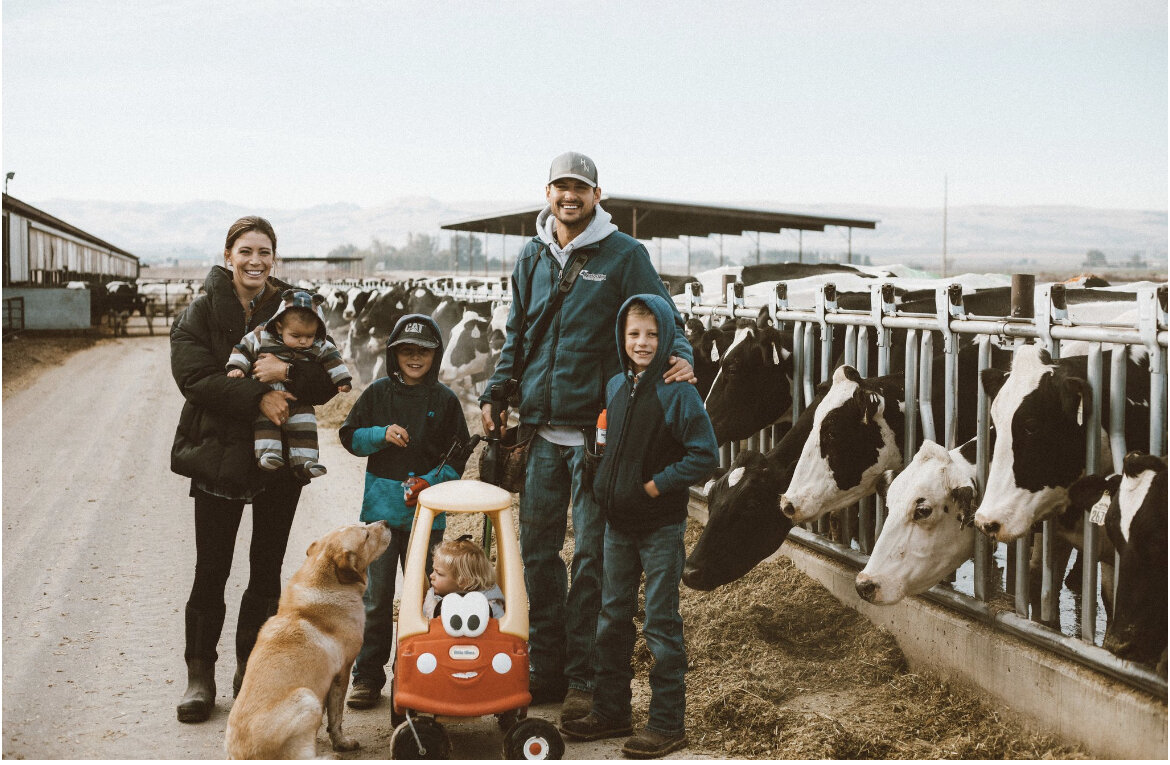 A picture of a family standing at a farm