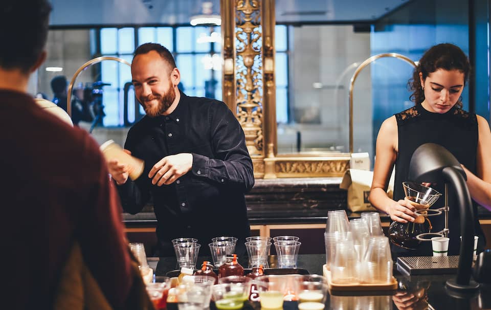 Two people tending a bar