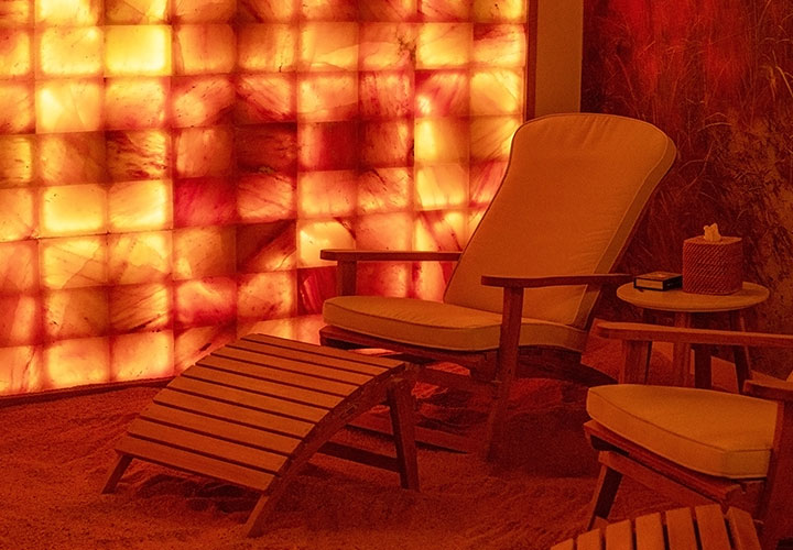 A picture of a chair in a room with orange lighting